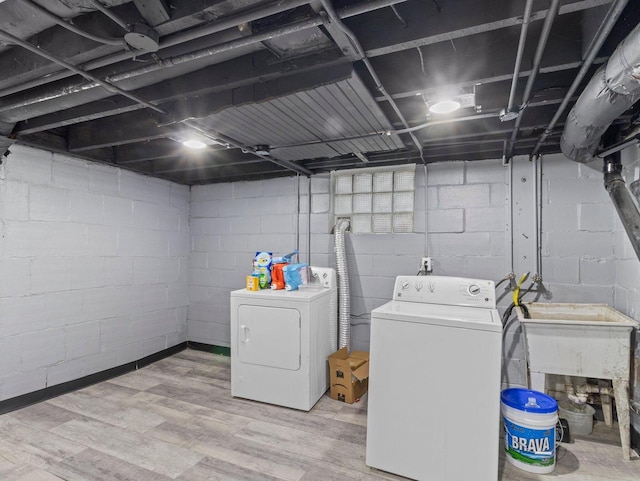 washroom featuring hardwood / wood-style flooring and washing machine and clothes dryer