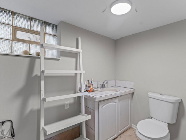 bathroom featuring tile patterned flooring, vanity, and toilet