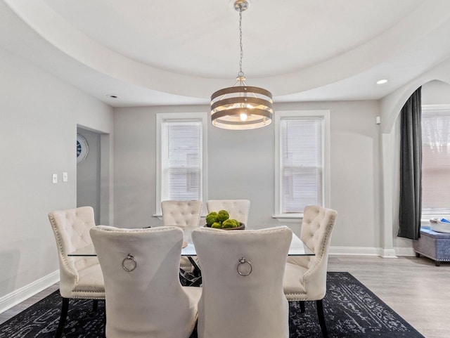 dining room with hardwood / wood-style floors, an inviting chandelier, and a wealth of natural light