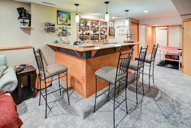 bar featuring carpet flooring and decorative light fixtures