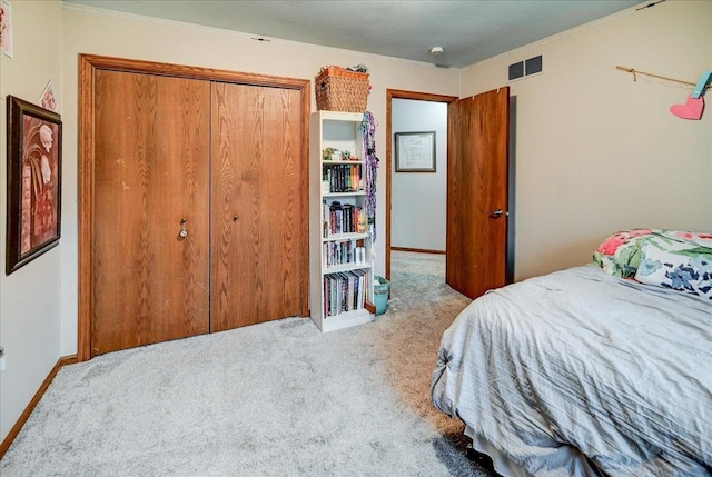 bedroom featuring a closet and light colored carpet