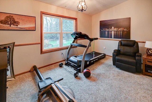 workout room with a chandelier, carpet floors, and lofted ceiling