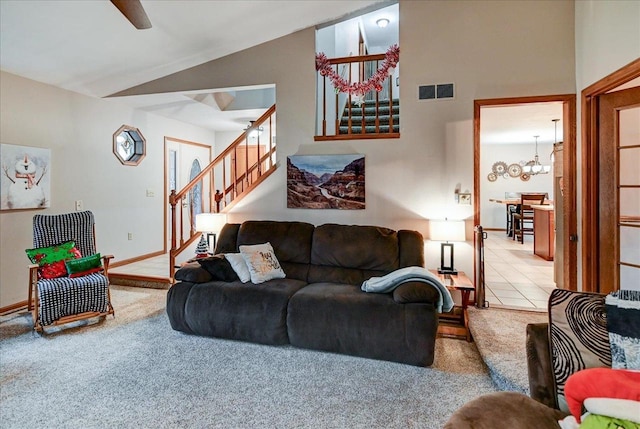 living room with light carpet, vaulted ceiling, and a notable chandelier