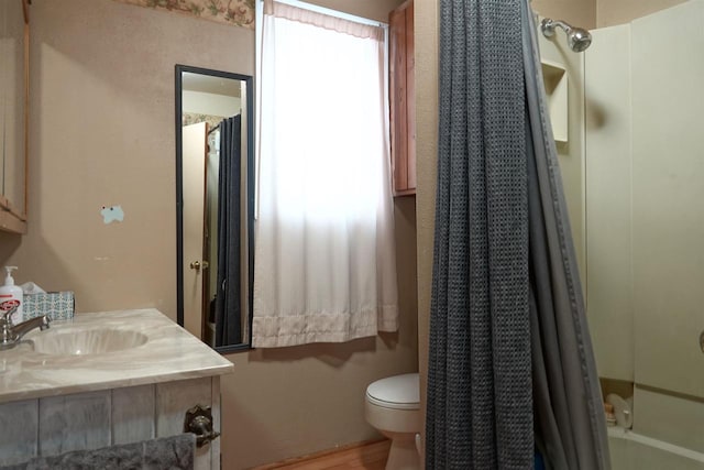 bathroom with hardwood / wood-style flooring, vanity, and toilet