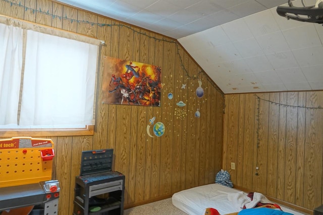 bedroom featuring wooden walls, carpet floors, and lofted ceiling