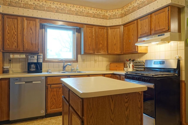 kitchen featuring backsplash, stainless steel dishwasher, black range with gas stovetop, sink, and a center island