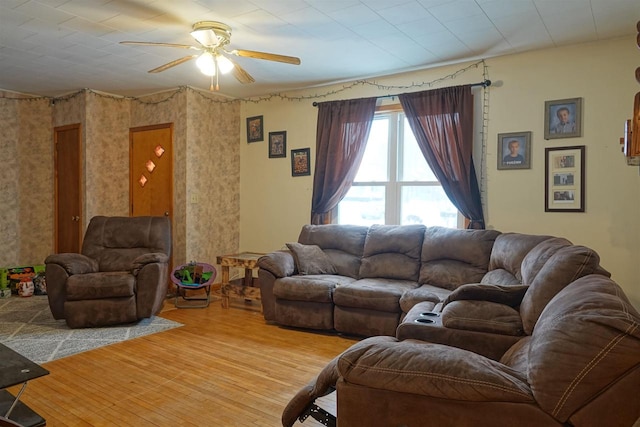 living room featuring wood-type flooring and ceiling fan