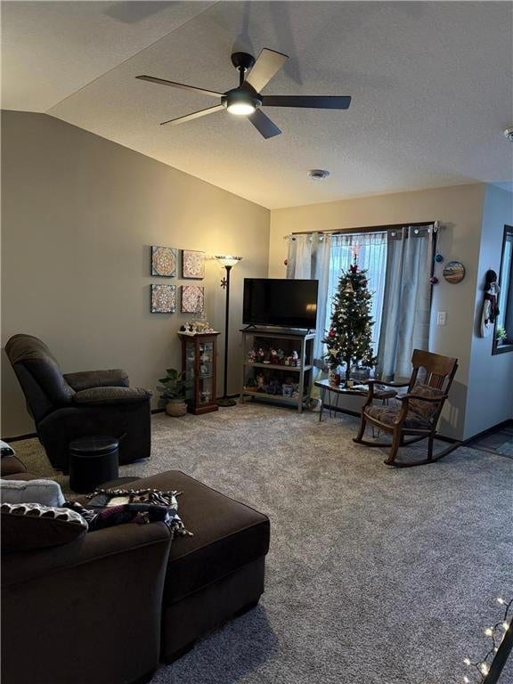 carpeted living room with ceiling fan, a textured ceiling, and vaulted ceiling