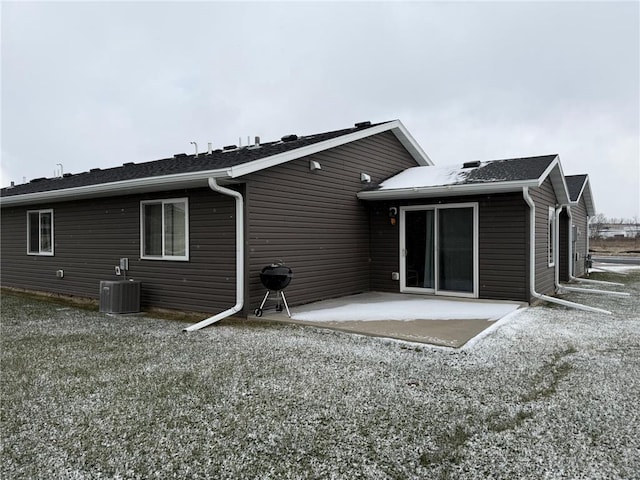 rear view of house featuring cooling unit and a patio area