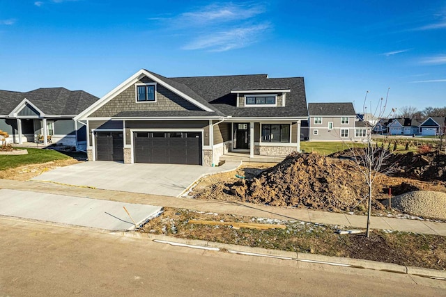 view of front facade featuring stone siding, concrete driveway, and an attached garage