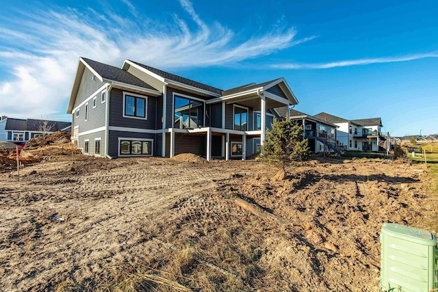 rear view of property featuring stairs