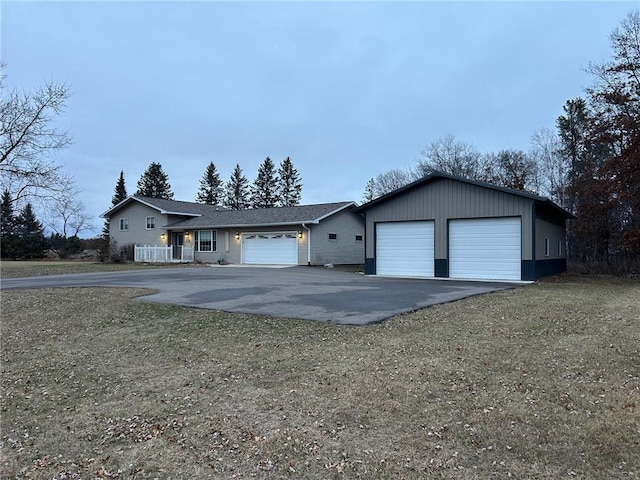 single story home featuring a garage and a front yard