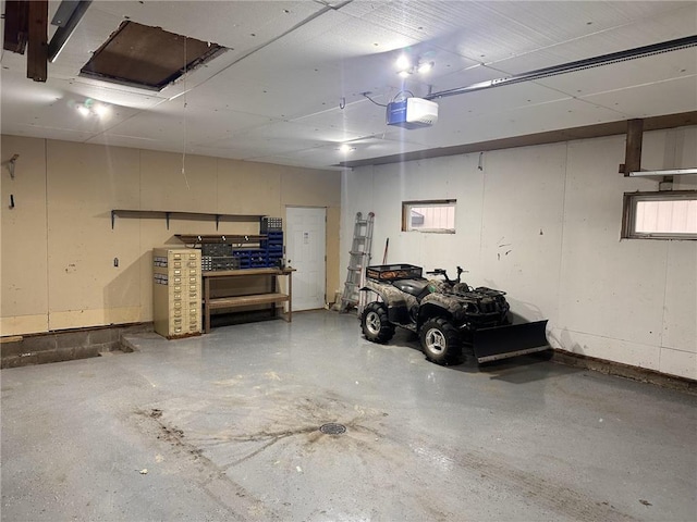 garage featuring a workshop area and a garage door opener