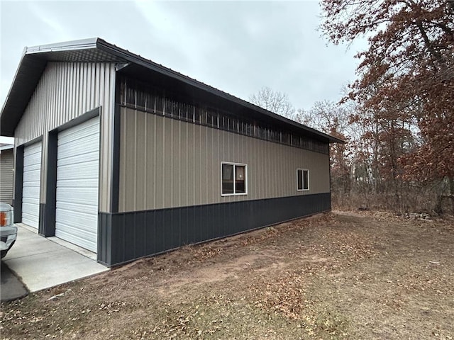 view of side of property featuring a garage and an outbuilding