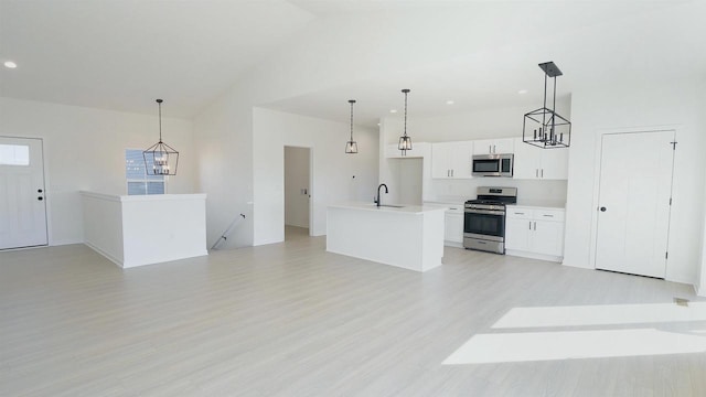 kitchen featuring a sink, high vaulted ceiling, appliances with stainless steel finishes, and open floor plan