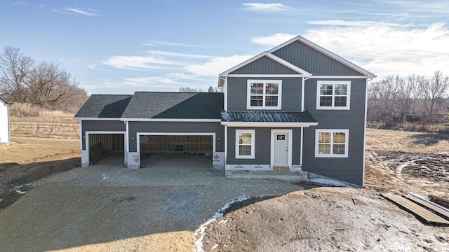 view of front of house with a garage, driveway, and a shingled roof