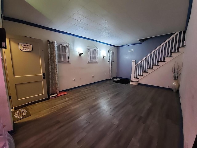 entrance foyer featuring ornamental molding and dark wood-type flooring