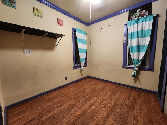 unfurnished room featuring crown molding and dark hardwood / wood-style floors