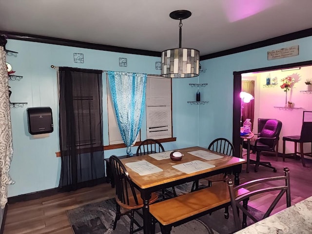 dining area featuring hardwood / wood-style flooring and ornamental molding