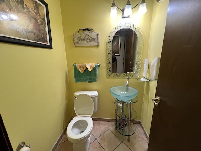 bathroom with tile patterned flooring, toilet, and sink