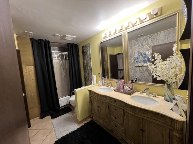 bathroom featuring tile patterned flooring, vanity, curtained shower, and toilet