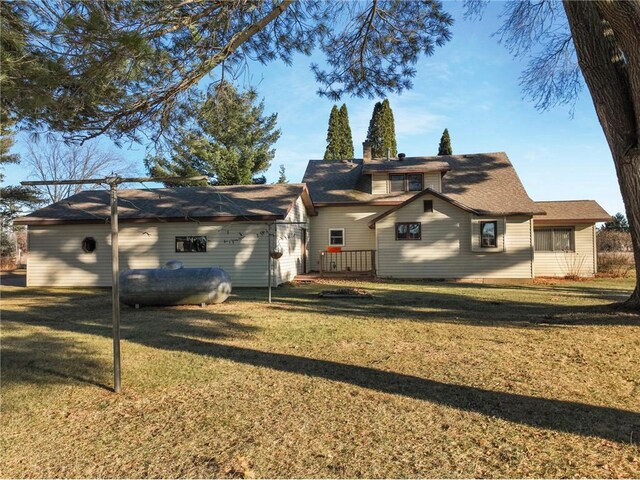 rear view of property with a yard