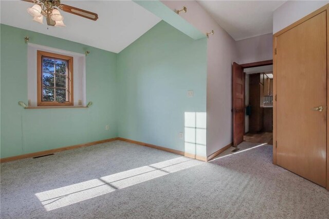 carpeted empty room featuring ceiling fan