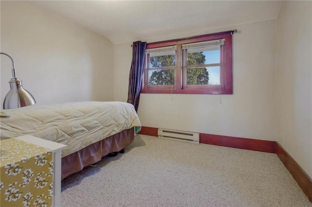 bedroom featuring baseboard heating, carpet floors, and lofted ceiling