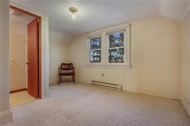 bonus room featuring vaulted ceiling, a textured ceiling, light carpet, and a baseboard heating unit