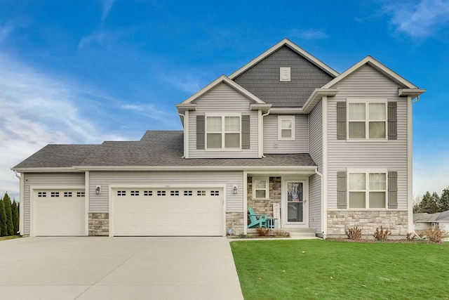 view of front facade featuring a garage and a front lawn