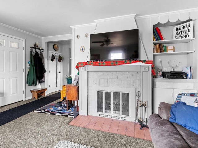 carpeted living room featuring a fireplace, ceiling fan, and crown molding