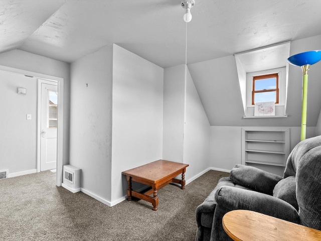 living room with vaulted ceiling and dark colored carpet