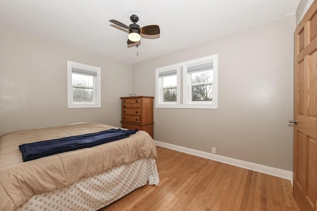 bedroom with light hardwood / wood-style floors and ceiling fan