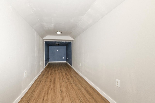 hall featuring hardwood / wood-style flooring and lofted ceiling