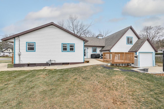 rear view of house with a yard and a deck