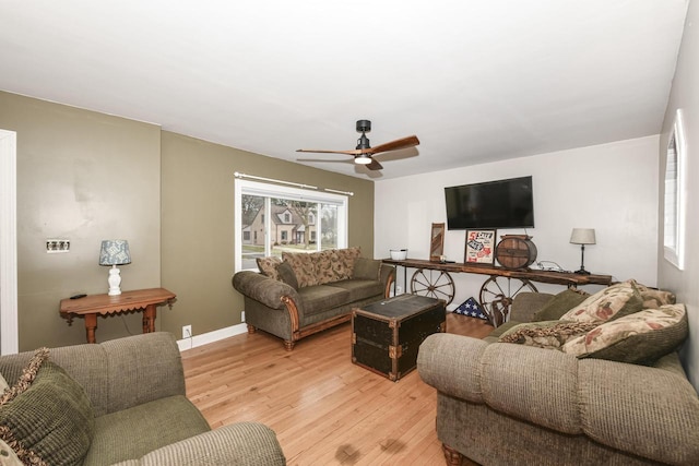 living room with ceiling fan and light hardwood / wood-style flooring