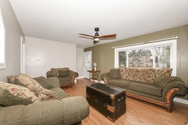 living room featuring ceiling fan and light hardwood / wood-style floors