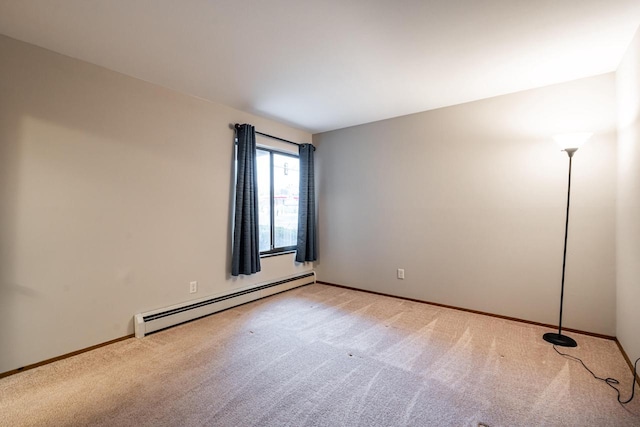 spare room with light colored carpet and a baseboard radiator