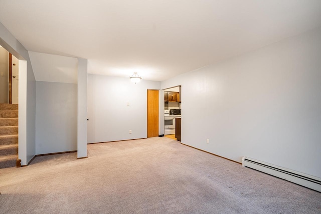 carpeted empty room featuring a baseboard radiator