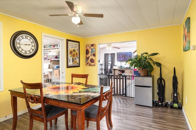 dining room with ceiling fan, ornamental molding, and hardwood / wood-style flooring