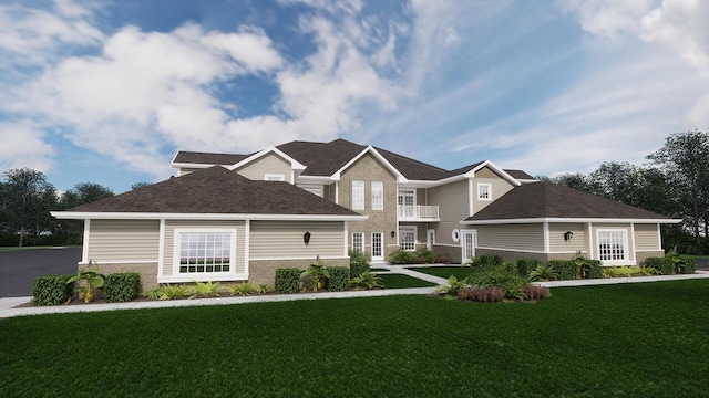 view of front facade featuring a balcony and a front yard