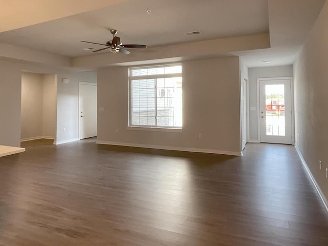 empty room with dark hardwood / wood-style floors and ceiling fan