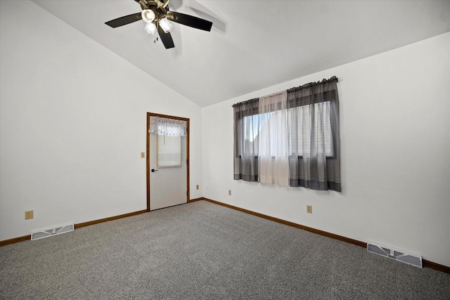 carpeted empty room with ceiling fan and lofted ceiling