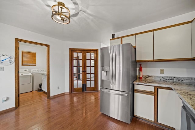 kitchen featuring white cabinets, stainless steel refrigerator with ice dispenser, light hardwood / wood-style flooring, and french doors