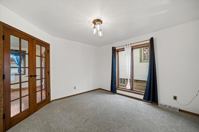 empty room with carpet and french doors