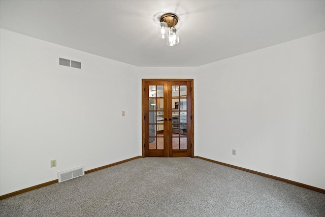 carpeted empty room with french doors