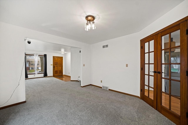 carpeted empty room with french doors