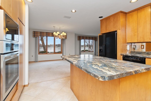 kitchen with black appliances, light colored carpet, dark stone counters, and an inviting chandelier