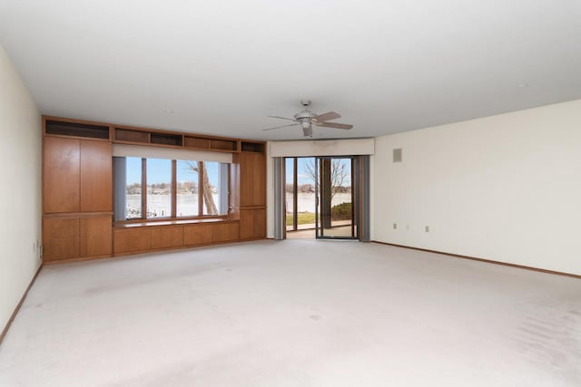 unfurnished room featuring light colored carpet and ceiling fan