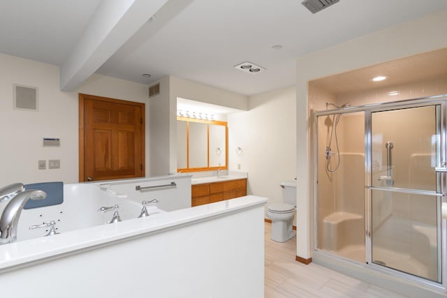 bathroom with vanity, toilet, and a shower with door